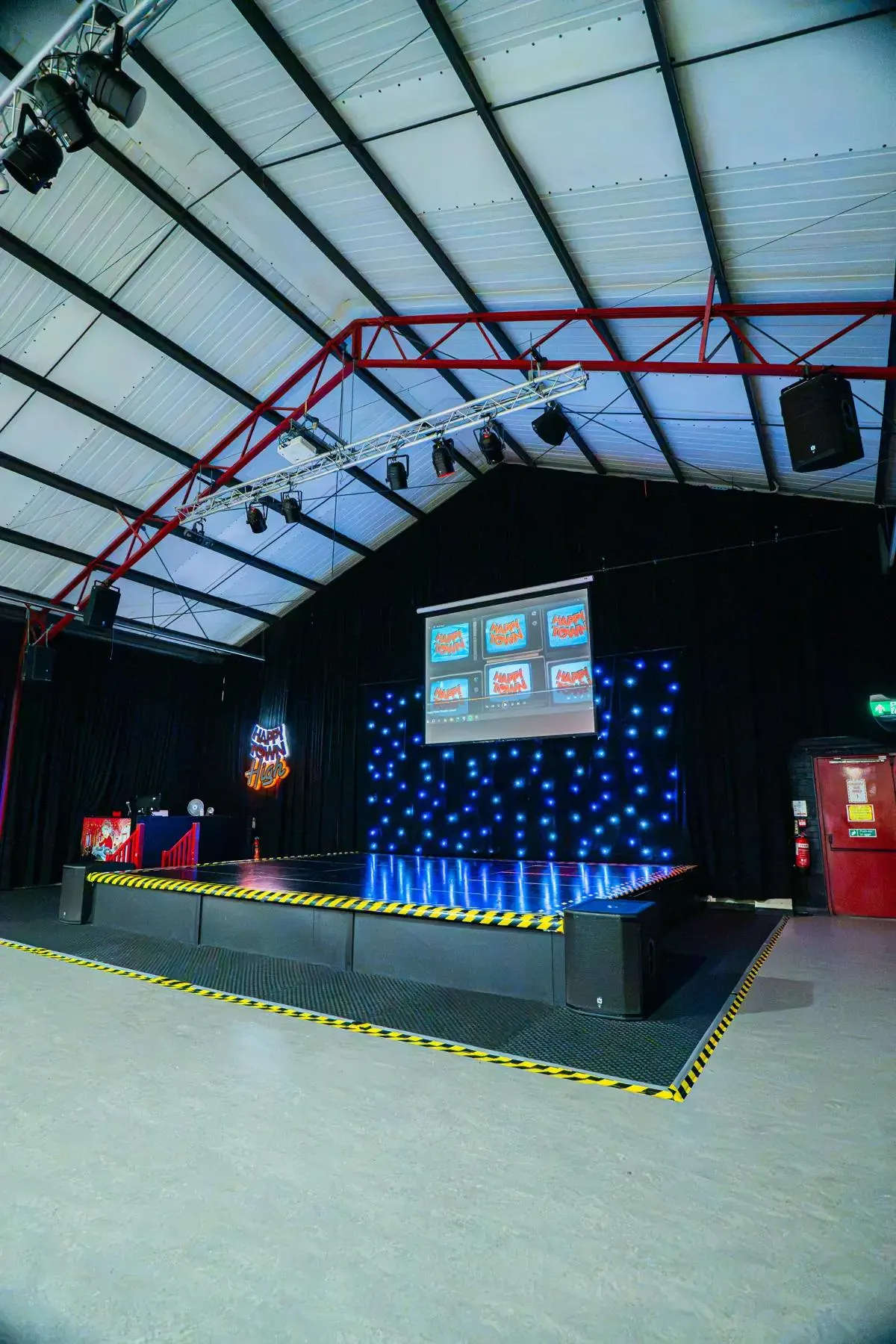 The Happy Town High stage with lights and screen