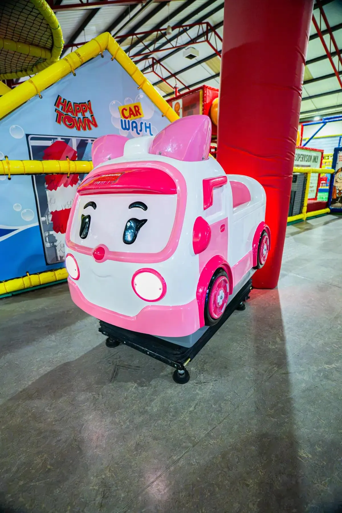A pink ambulance ride-on in the Happy Town arcade